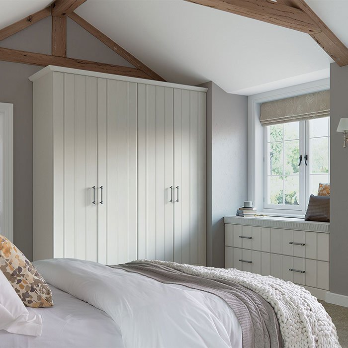 Pembrook grooved fitted wardrobes and matching fitted drawers in white wood grain.