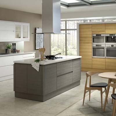 Kassel 3 tone kitchen. Tall wall units with built in oven in Odessa Oak wood, wall and base units in legno white and a kitchen island in Terra Oak with drawers and cupboards