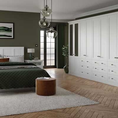 Carmen Fitted shaker wardrobes wall to wall with mirror inserts in Porcelain. Matching bed side table and headboard