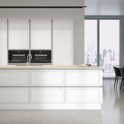 Gladstone modern painted MDF kitchen cabinets with grooved detail in white. True handleless rail in silver. Tall wall units with 2 ovens side by side and a kitchen island with deep drawers