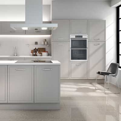 Jones mock in-frame kitchen in Light grey. Tall units with built in oven and kitchen island with cupboards