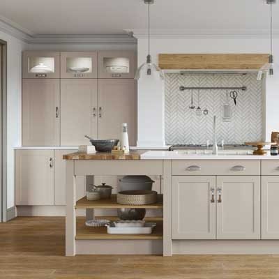 Parker Painted MDF Shaker style kitchen cabinets in Taupe Grey. Tall units with Glass Inserts and open shelving. Kitchen Island with cupboards and drawers and open shelving at one end