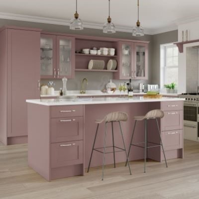 Allerford Antique Rose, Dusty pink shaker kitchen with glass insert wall unit doors open shelving, full height tall units and a kitchen island with seating and drawers